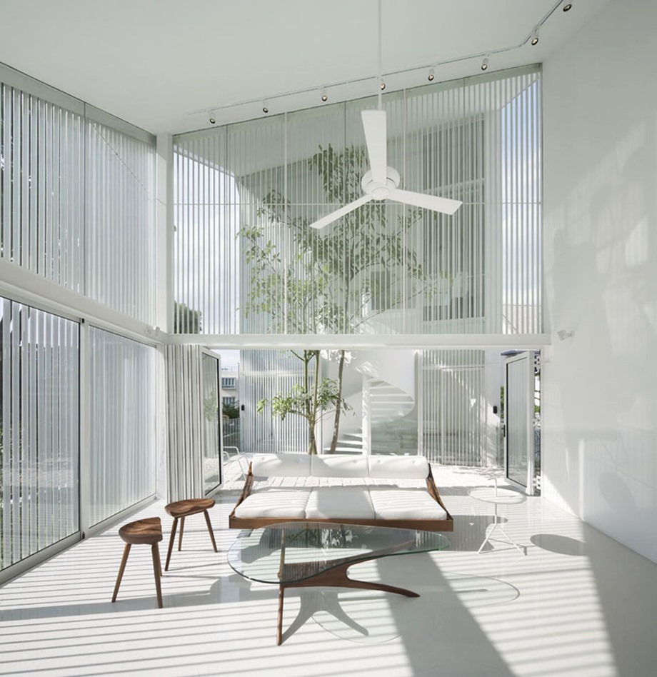 บ้านผนังกระจกฟาซาดระแนงสีขาวล้อมรอบ
